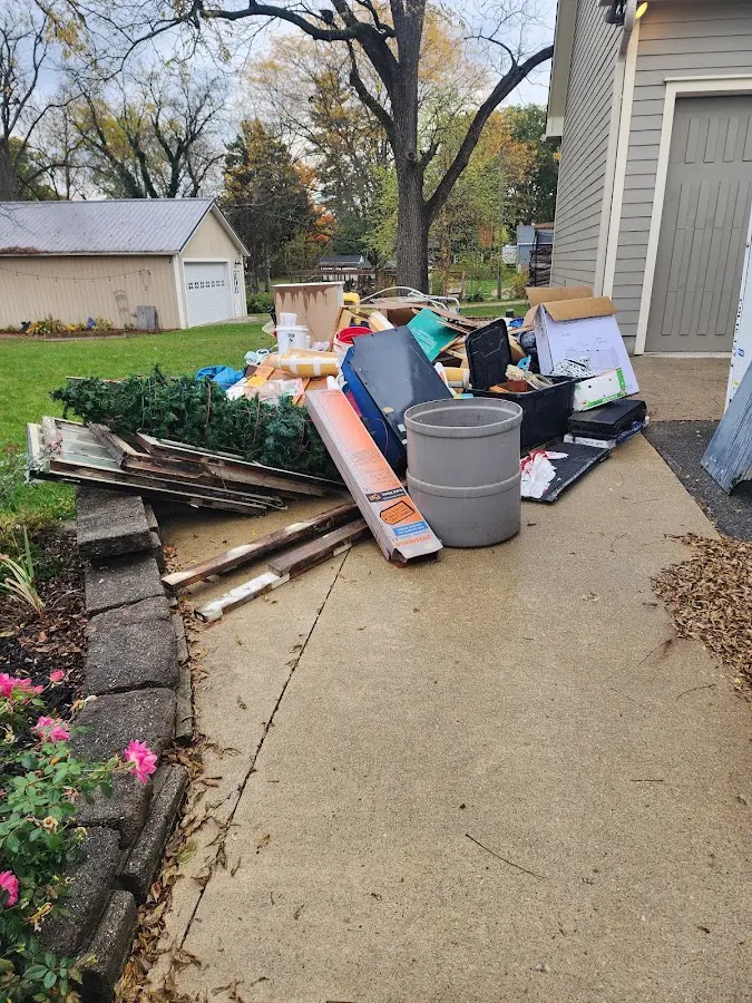 Dumpster being loaded with debris for Roofing Dumpster Rental in Maybrook